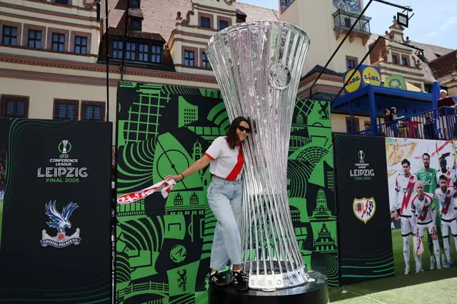 Rayo Vallecano fan having picture with giant Conference League trophy