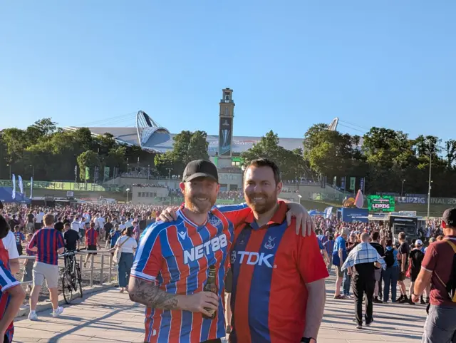 Two Palace fans pose outside Leipzig stadium