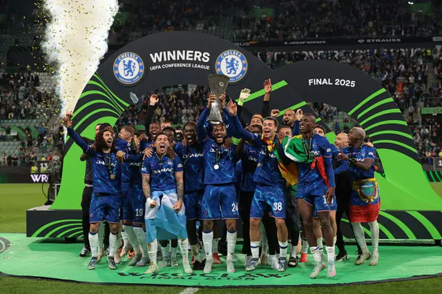 Chelsea lift Conference League trophy on a stage on the pitch