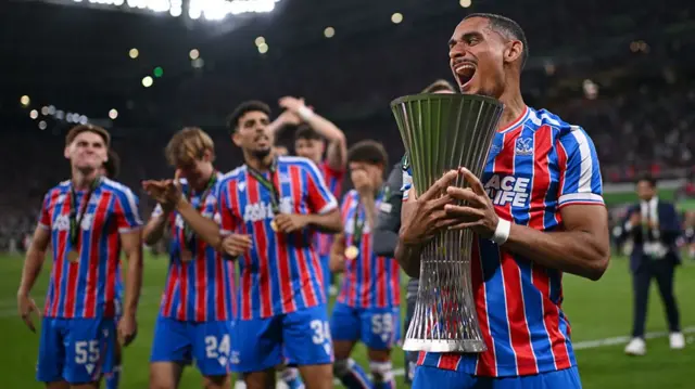 Maxence Lacroix celebrates with the trophy