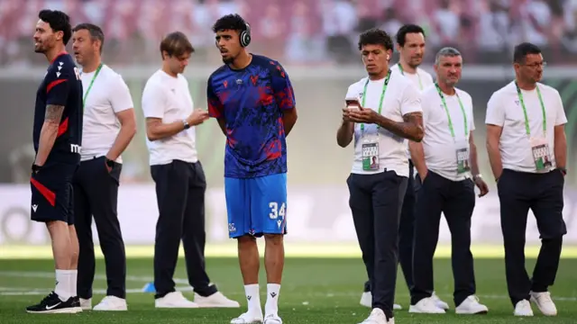 Chadi Riad inspects the pitch