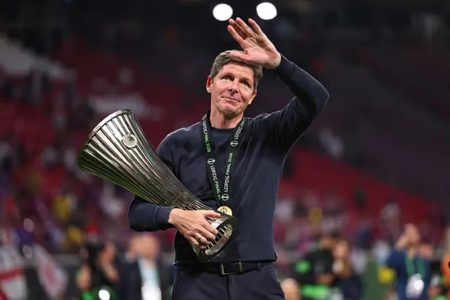 Oliver Glasner holding Conference League trophy and waving