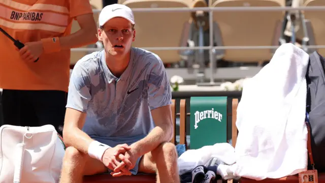 Jannik Sinner sits on his chair at a change of ends