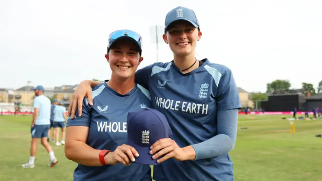 Tilly Corteen-Coleman poses with her England cap alongside Alice Capsey