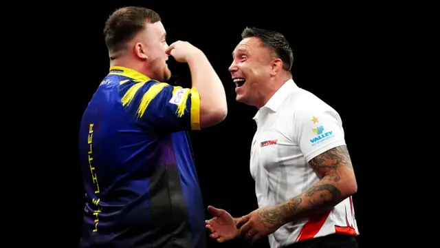 Luke Littler (left) celebrates winning his semi-final against Gerwyn Price on finals night of the 2026 BetMGM Premier League at The O2 in London