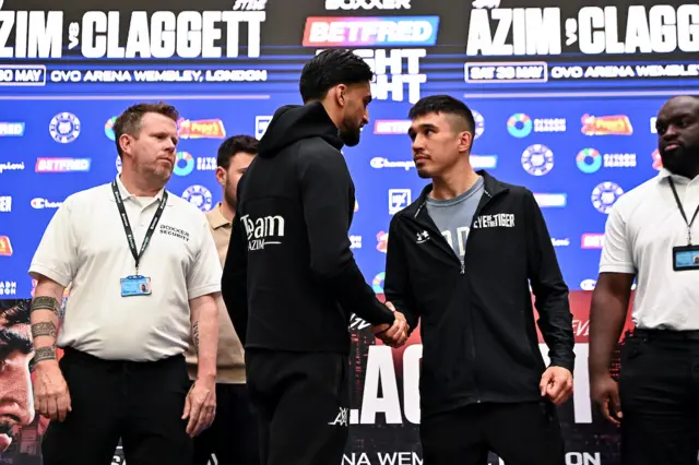 Adam Azim and Steve Claggett shake hands