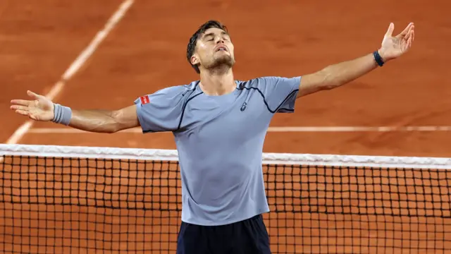 Raphael Collignon celebrates with his arms outstretched
