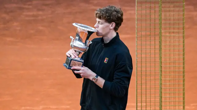 Jannik Sinner kisses the trophy after winning in Rome
