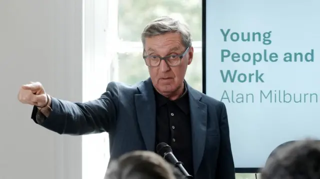 Alan Milburn pointing with his right hand