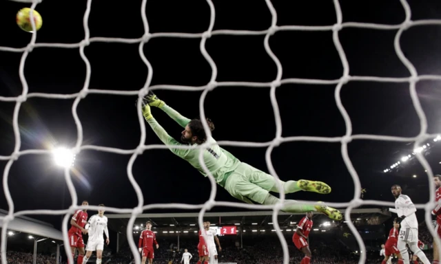 Fulham's Harrison Reed scores their second goal past Liverpool's Alisson Becker