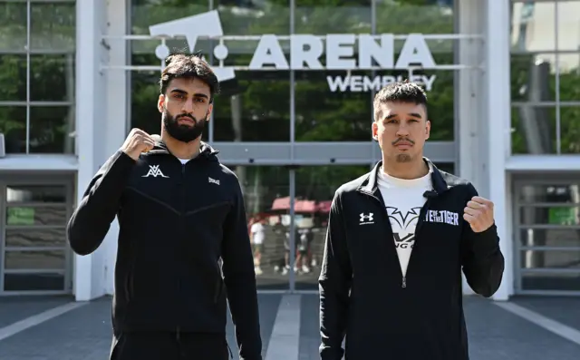 Adam Azim and Steve Claggett hold up their fist