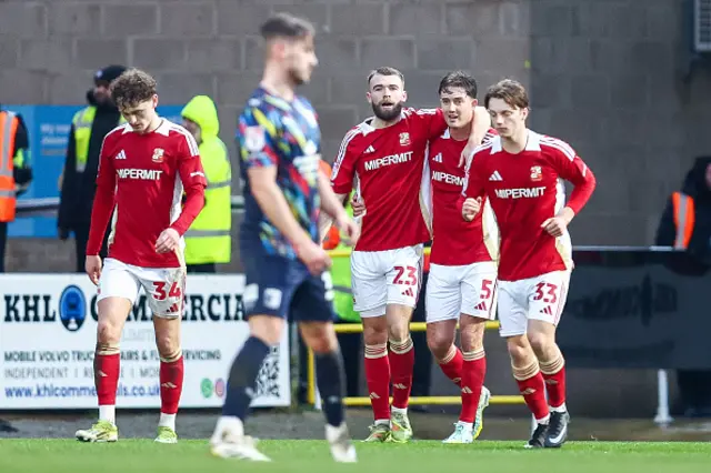 Aaron Drinan of Swindon Town is congratulated