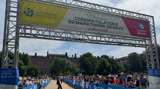 The arch of the finish line, with crowds visible on either side