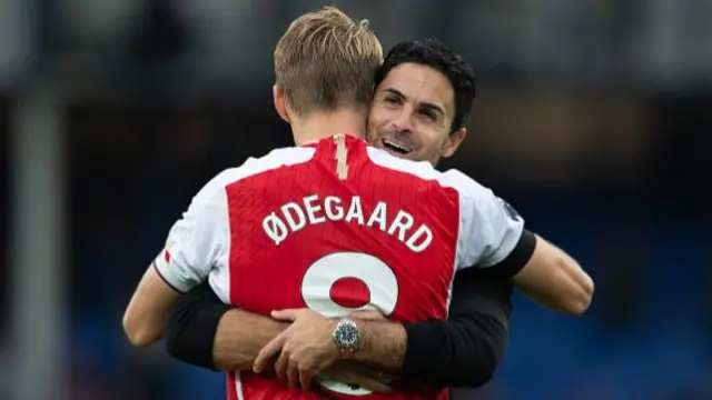 Arsenal manager Mikel Arteta embraces Martin Odegaard of Arsenal