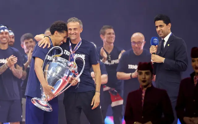 Captain, Marquinhos and head coach, Luis Enrique of Paris Saint-Germain react with Champions League Trophy during the celebrations