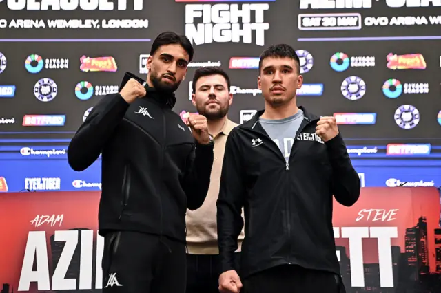 Adam Azim and Steve Claggett hold up their fists