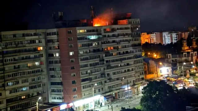 A fire burns on the roof of a 10-story block of flats after a drone crashed into the building, causing an explosion and injuring two people, near the border with Ukraine, in Galati, Romania, in this handout image released on May 29, 2026.