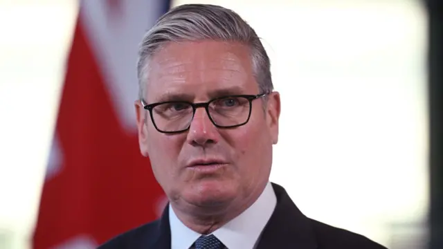 A headshot of Keir Starmer with the background blurred