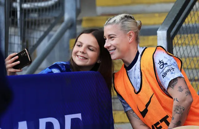 Beth England takes a selfie with a fan