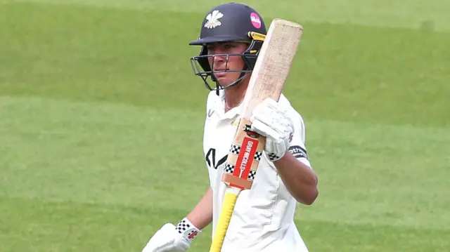 Adam Thomas of Surrey raises his bat