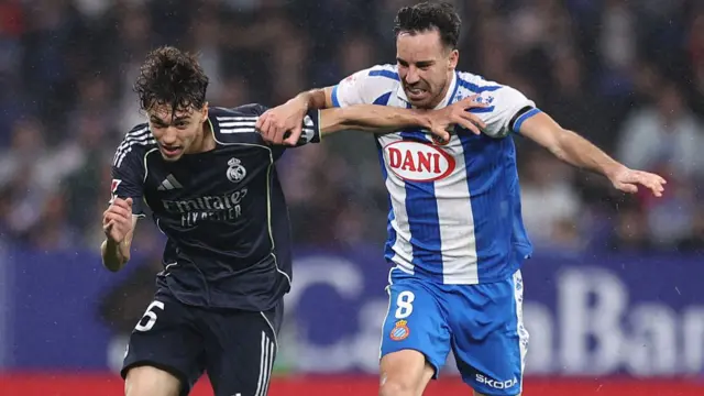 Real Madrid's Spanish midfielder #45 Thiago Pitarch fights for the ball with Espanyol's Spanish midfielder #08 Edu Exposito