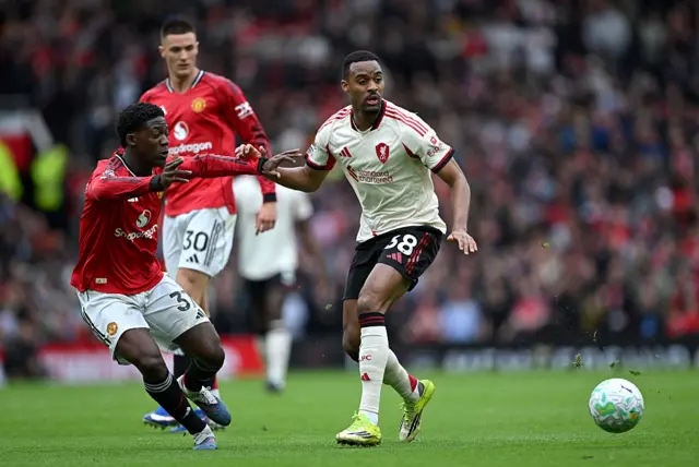 Kobbie Mainoo of Manchester United is challenged by Ryan Gravenberch of Liverpool during the Premier League match between Manchester United and Liverpool at Old Trafford.