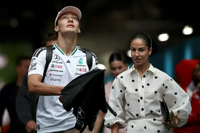George Russell and his partner Carmen arrive in the paddock