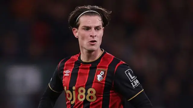 Alex Scott of Bournemouth in red and black striped shirt