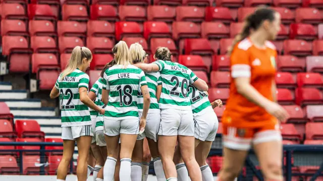 Celtic players celebrate their late winner at Hampden