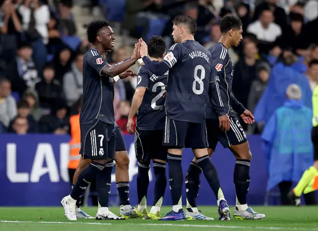 Vinicius Junior (L) celebrates scoring