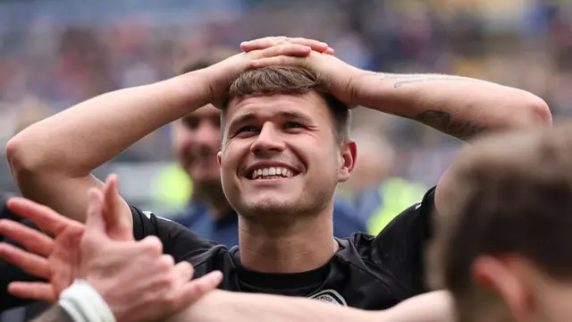 Zak Brunt with his hands on his head but a big smile after Boreham Wood beat Carlisle