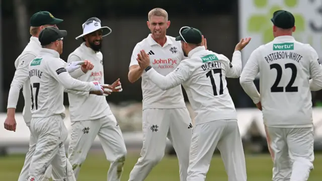 Olly Stone (centre) celebrates a wicket with Notts teammates