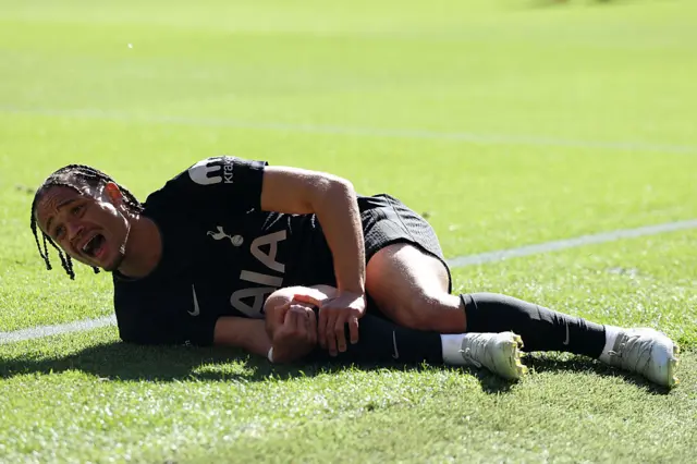 Xavi Simons holding his knee in pain