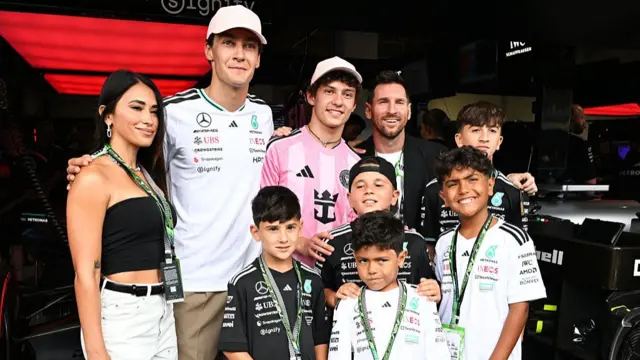 Mercedes drivers George Russell and Kimi Antonelli with Lionel Messi and his family