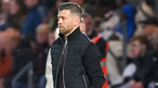 Luke Garrard on the Boreham Wood sideline on Wednesday night