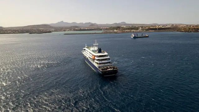 Cruise ship MV Hondius sailing outside a port