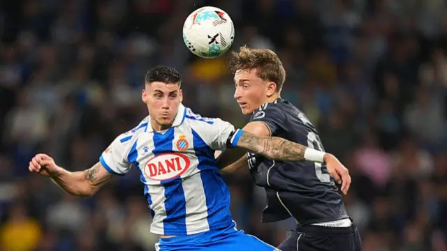 Roberto Fernandez of RCD Espanyol and Dean Huijsen of Real Madrid contest an aerial ball