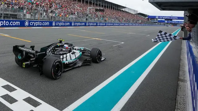 Rafael Nadal waves the checkered flag for Kimi Antonelli during the 2026 Miami Formula One Grand Prix