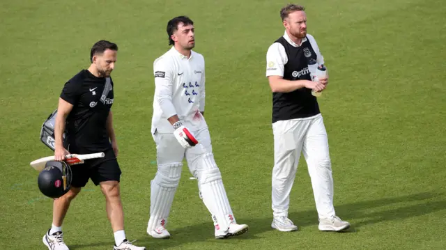 Tom Haines leaves the field injured