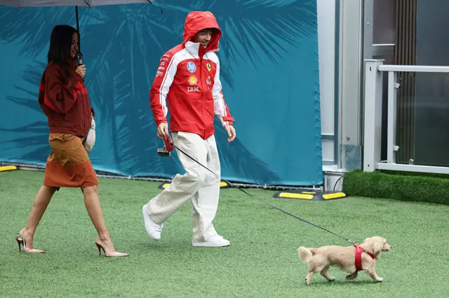Charles Leclerc arrives with his Alex and dog Leo to the paddock in Miami