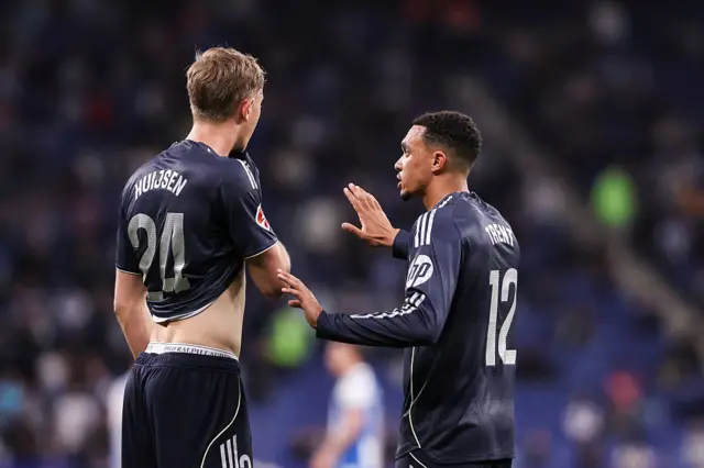 Trent Alexander-Arnold of Real Madrid CF speaks with teammate Dean Huijsen