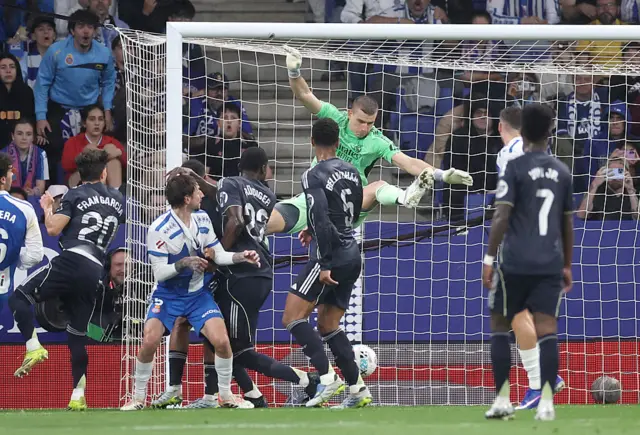 Andriy Lunin jumps for the ball