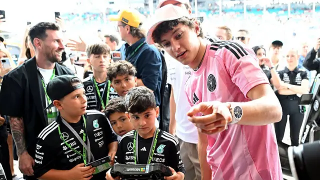 the Messis at the Mercedes garage