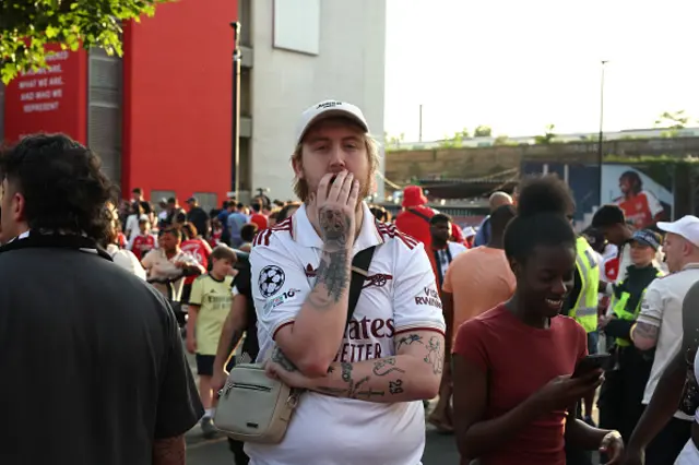 An Arsenal fan reacts to his sides defeat as fans