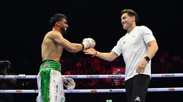 Azim embraces his coach