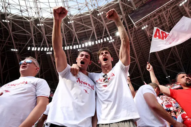 Fans of Arsenal react