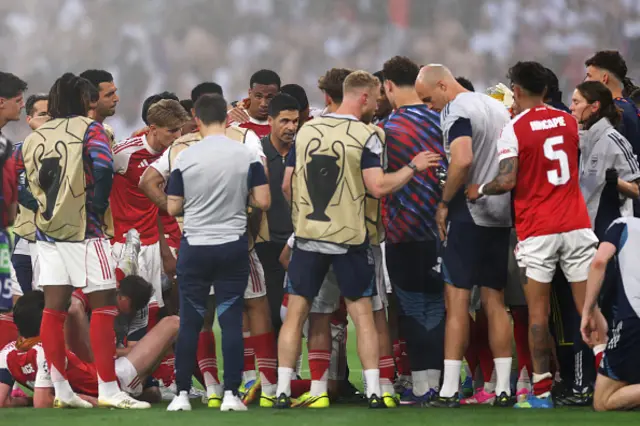 Mikel Arteta, Manager of Arsenal, speaks with players