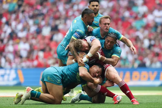 WIgan's Luke Thompson is tackled by Hull KR's Jesse Sue, Elliot Minchella, Jez LItten and Tom Amone.