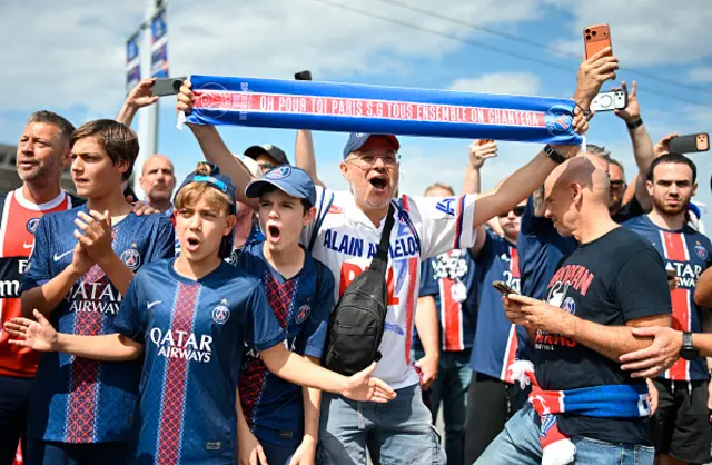 PSG supporters cheer as they march towards the stadium in Budapest