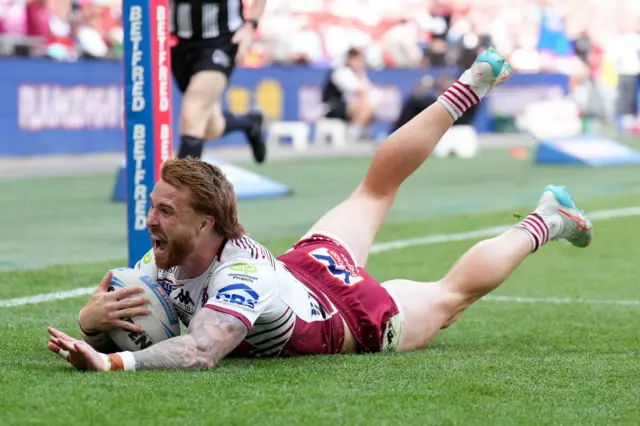 Adam Keighran of Wigan Warriors scores a try